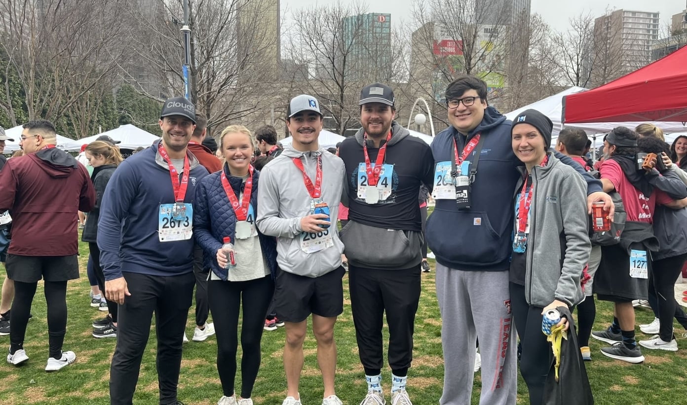 People smiling with their medals after an outdoor race