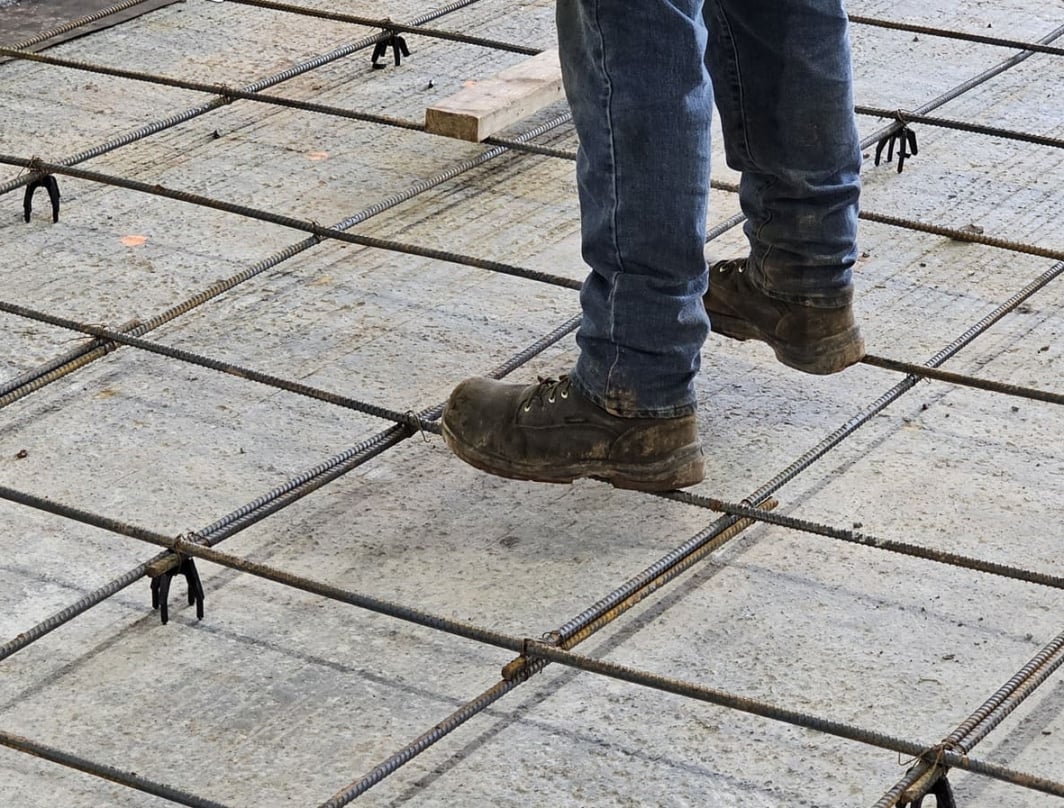 Worker standing over concrete