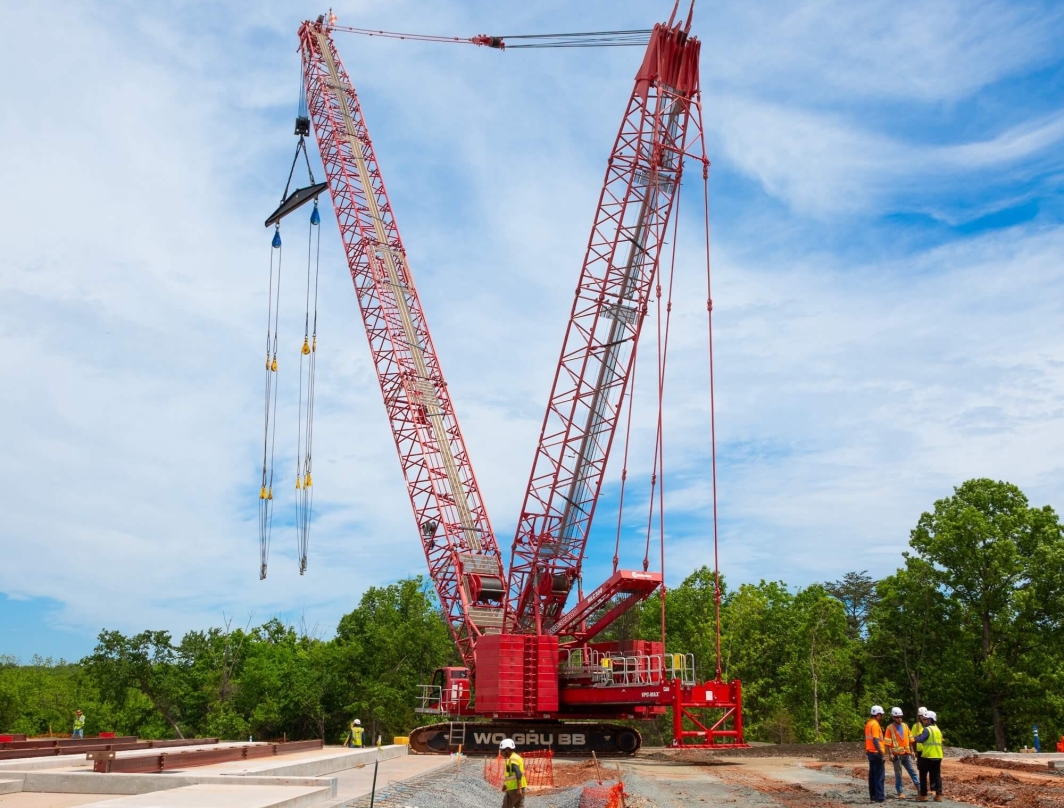WWMC workers at a construction site with a red crane